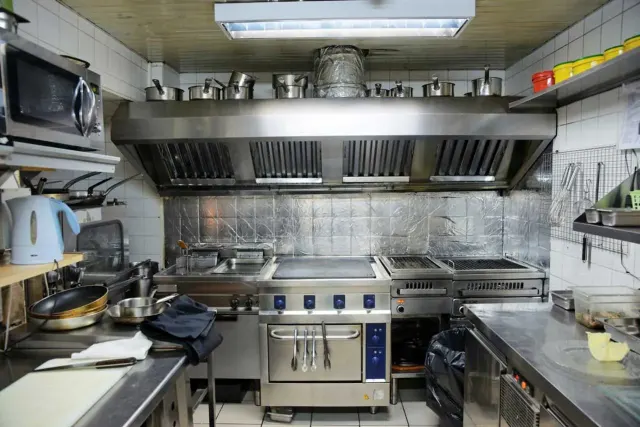 Professional hood cleaning technician servicing a restaurant exhaust system in Houston